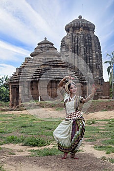 Dancer wears traditional costume and posing at Sukasari Temple,Bhubaneswar, Odisha, India. Indian Culture