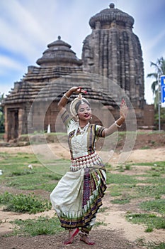 Dancer wears traditional costume and posing at Sukasari Temple,Bhubaneswar, Odisha, India. Indian Culture