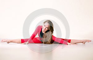 Dancer woman sit on half twine