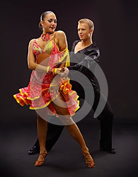 Dancers against black background