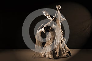 Dancers in ballroom against black background