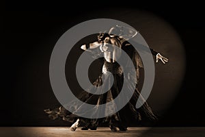 Dancers in ballroom against on black background