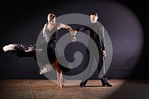 Dancers in ballroom  on black background