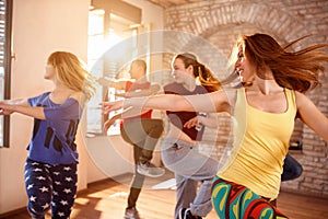 Dancers dancing in dancing studio