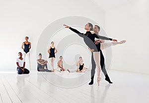 Dancers are a great breed of people. Studio shot of a young man and woman performing a ballet recital against a grey