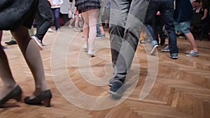 Dancers perform lindy hop dance at the swing festival. Dancing legs close up.