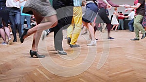 Dancers perform lindy hop dance at the swing festival. Dancing legs close up.