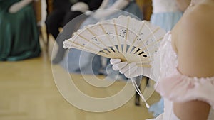 Dances of the 19th century. Lady with a fan at a ball, costumes from the 18th century. Victorian woman in a ball gown