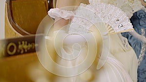 Dances of the 19th century. Lady with a fan at a ball, costumes from the 18th century. Victorian woman in a ball gown