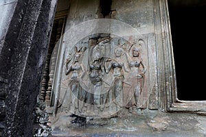 Dancing apsara stone carving on the wall in Angkor Wat