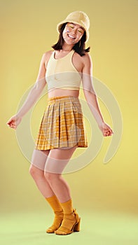 Dancing, Asian woman and retro fashion isolated on a yellow background in a studio. Happy and stylish girl model with