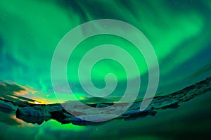 Dancing aurora over a glacier lagoon