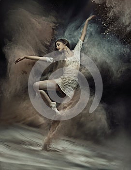 Dancing ballet dancer with dust in the background