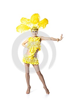 Beautiful young woman in carnival, stylish masquerade costume with feathers dancing on white studio background. Concept