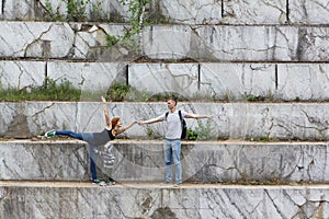 Dancing couple training on a travel in free time in a marble pit