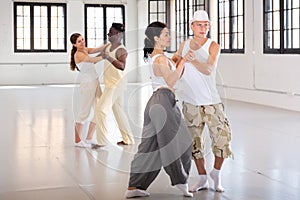 Dancing couples enjoying salsa or bachata