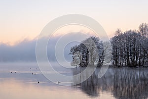 Dancing fairies at the lake, calm water and reflections at sunrise.