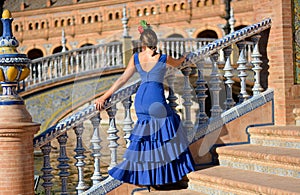 The beautiful woman with flamenco dress at Plaza de Espana Seville Spain photo