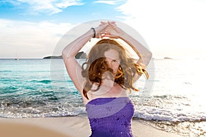 Dancing girl at Ibiza sunset in Cala Conta photo