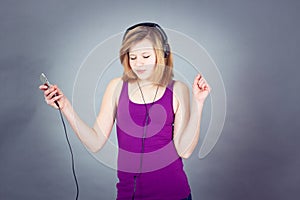 Dancing happy teenager girl listening to music