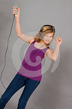 Dancing happy teenager girl listening to music