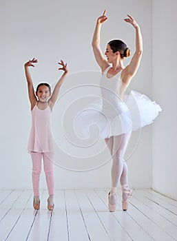 Dancing is like dreaming with your feet. a little girl practicing ballet with her teacher in a dance studio.