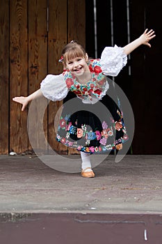 Dancing little girl acting on the stage