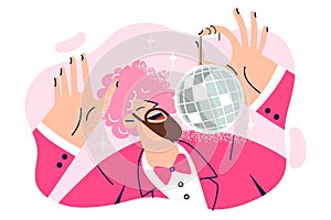 Dancing man with pink wig on head is holding disco ball and enjoying discotheque or music party