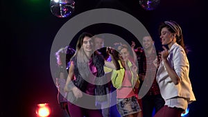 Dancing people with fun gladness on the discotheque of teens . Smoke background