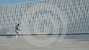 Dancing performer rehearsing street alone. Freestyle man practicing dance moves