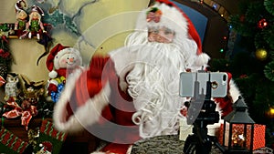Dancing Santa Claus congratulates remotely with video calling on Christmas and New Year.