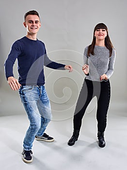 Dancing teenagers on gray background
