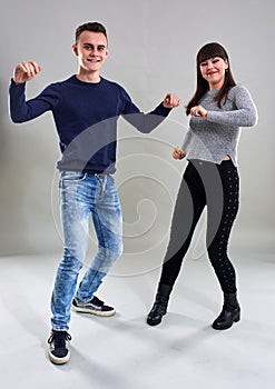 Dancing teenagers on gray background