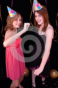 Dancing teens in party hats