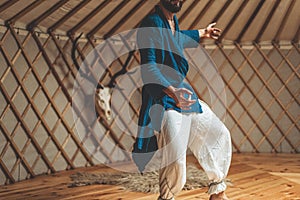 dancing warrior, ceremonial dance in a yurt.