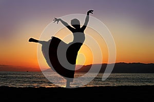 Dancing woman at sunset