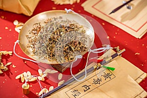 Dandelion, an ancient Chinese traditional Chinese medicine herbal medicine placed on a golden weighing plate