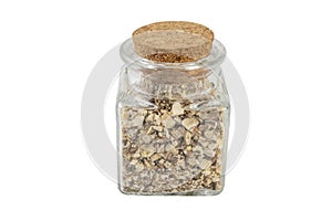 Dandelion root or in latin Taraxaci radix in a glass jar isolated on white background. medicinal healing herbs.