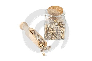 dandelion root or in latin Taraxaci radix in a glass jar and wooden scoop isolated on white background. medicinal healing herbs