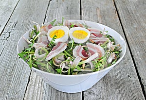 Dandelion salad with eggs and bacon