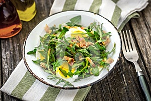 Dandelion salad with eggs and bacon