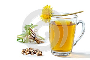 Dandelion tea background, herbal remedy. Dandelion tea, flower, leaves and root on wooden background.