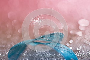 Dandelion with water drops on blue transparent leaf. the work of art. Selective focus