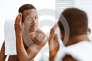 Black Man Examining Hair On Head Having Dandruff In Bathroom