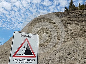 Danger access at your own risk sign in French with mountain