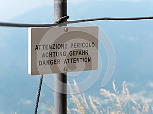 Danger Attention translation signpost or signboard mountain environment photo