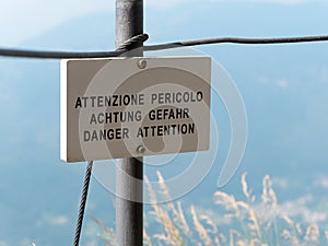 Danger Attention translation signpost or signboard mountain environment