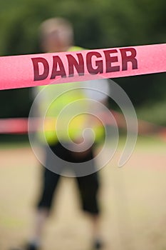 Danger Boundary Tape in a Field.