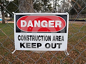 Danger construction area keep out sign on fence