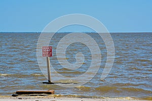 Danger culvert sign on the beach of Mississippi Gulf Coast. City of Long Beach, Florida USA